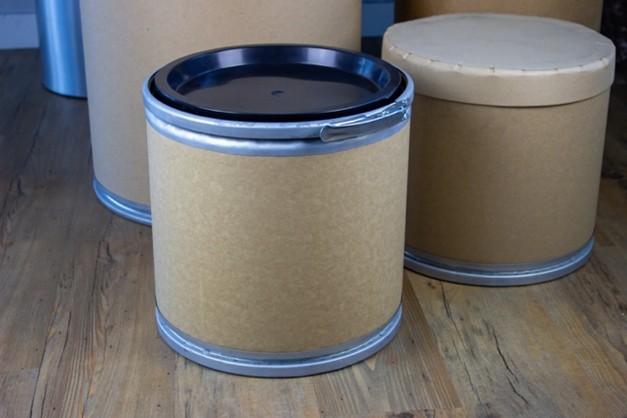 Industrial fibre drum with metal closure ring and lid used for hazardous solids packaging.